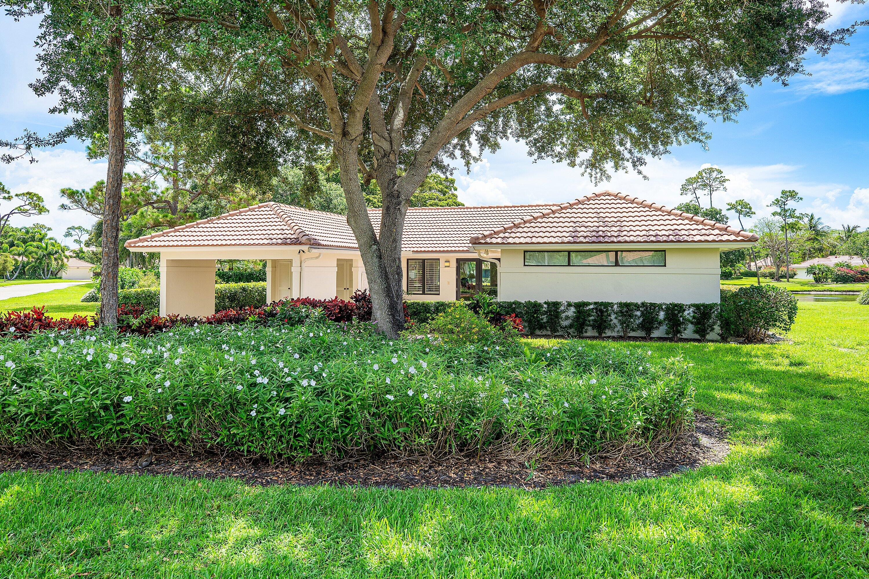 4365 Shell Drake Lane Boynton Beach, FL 33436 - Photo 42 of 56 a front view of a house with a garden