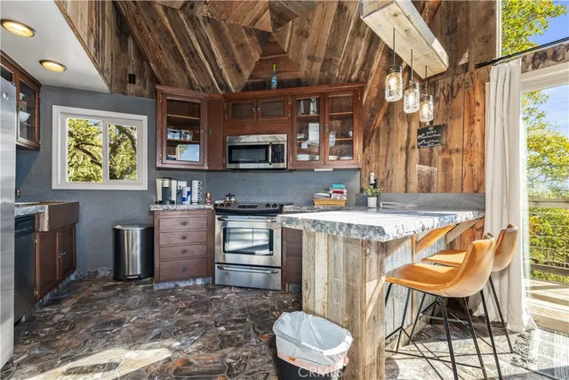 a kitchen with a sink appliances and cabinets