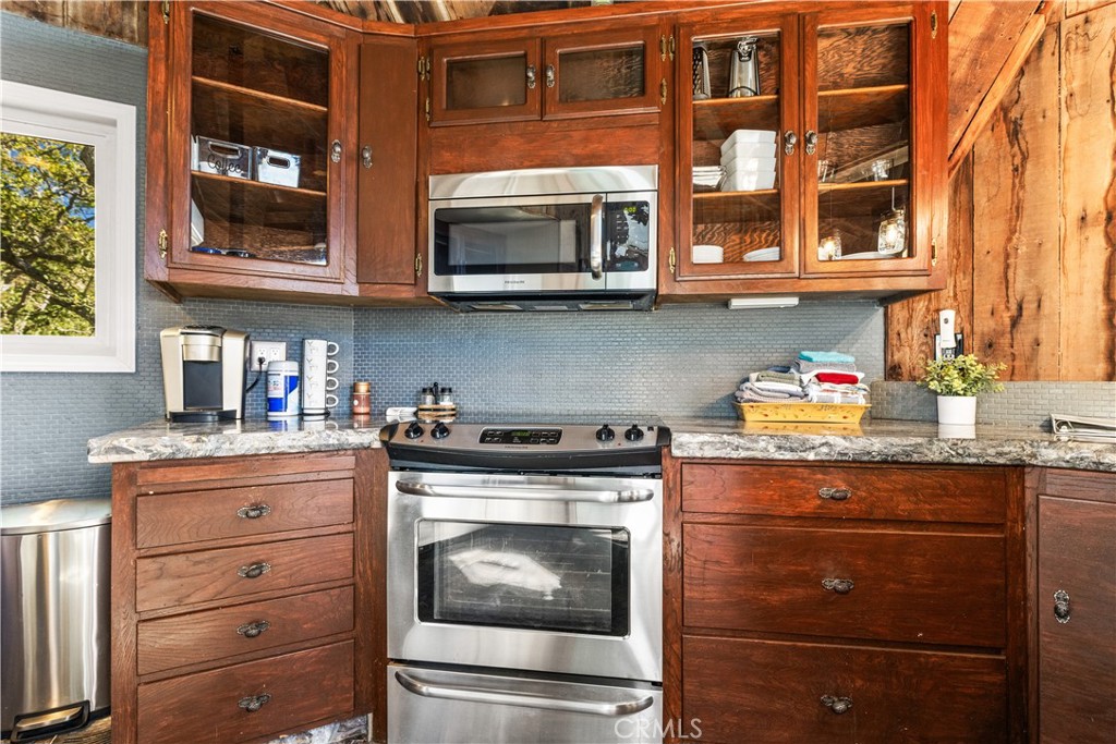 2178 Ridge Rider Road Bradley, CA 93426 - Photo 13 of 51 a kitchen with stainless steel appliances granite countertop a stove and a microwave