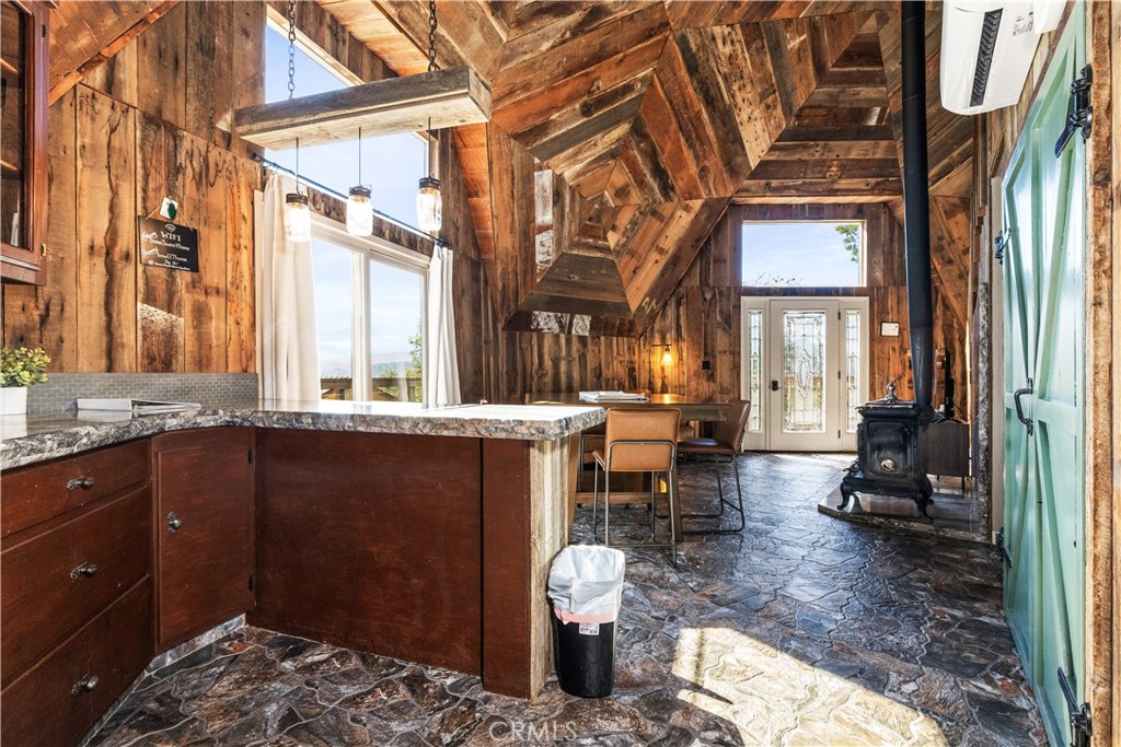 2178 Ridge Rider Road Bradley, CA 93426 - Photo 14 of 51 a living room with couches a large dining table and a fireplace with wooden floor