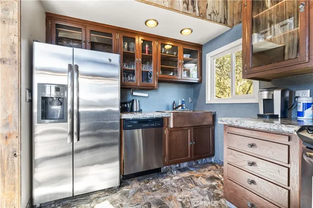 a kitchen with stainless steel appliances granite countertop a refrigerator and a sink