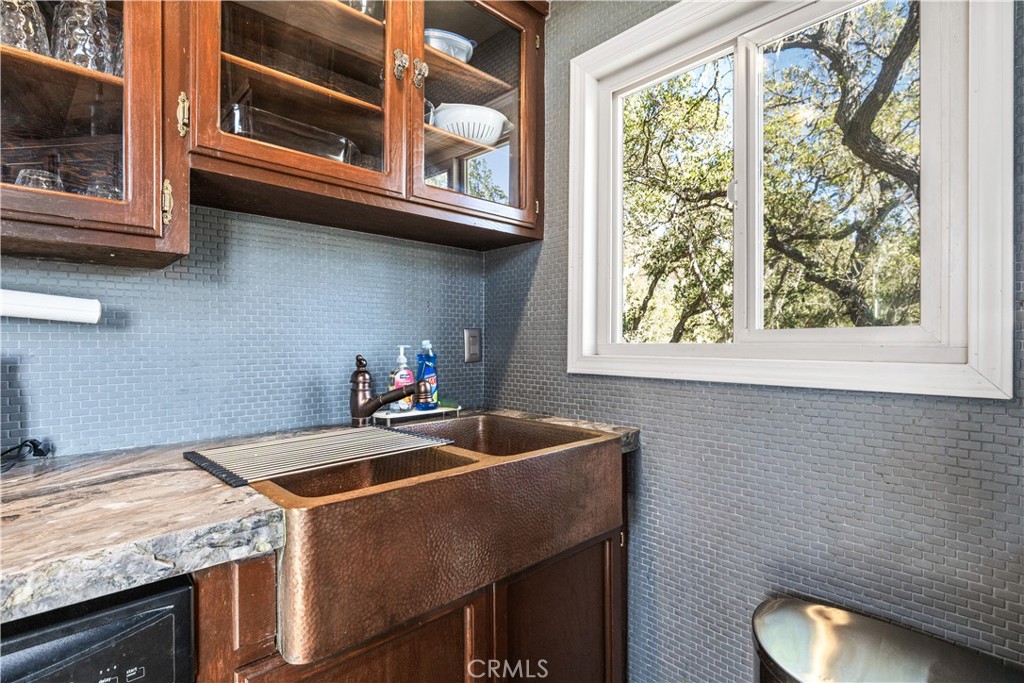 2178 Ridge Rider Road Bradley, CA 93426 - Photo 16 of 51 a kitchen with a sink cabinets and a wooden floor