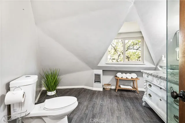 a living room with furniture a window and a potted plant