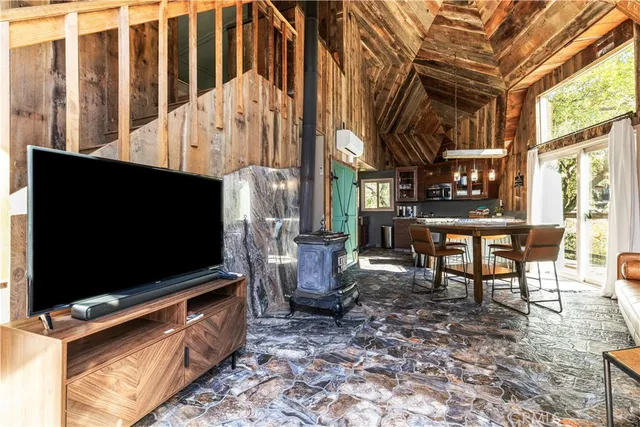 a living room with furniture flat screen tv and windows