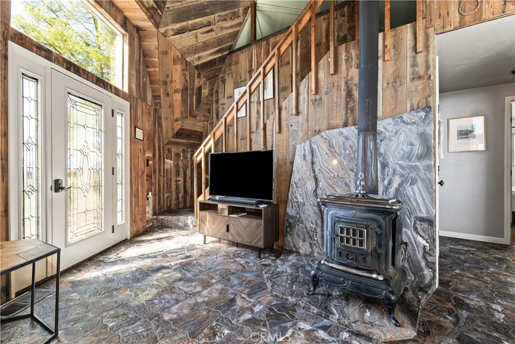 2178 Ridge Rider Road Bradley, CA 93426 - Photo 7 of 51 a living room with furniture a flat screen tv and a floor to ceiling window