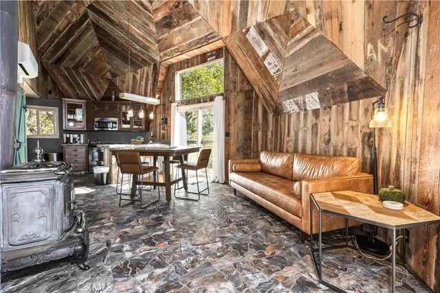 a view of a chairs and a table in the back yard of the house
