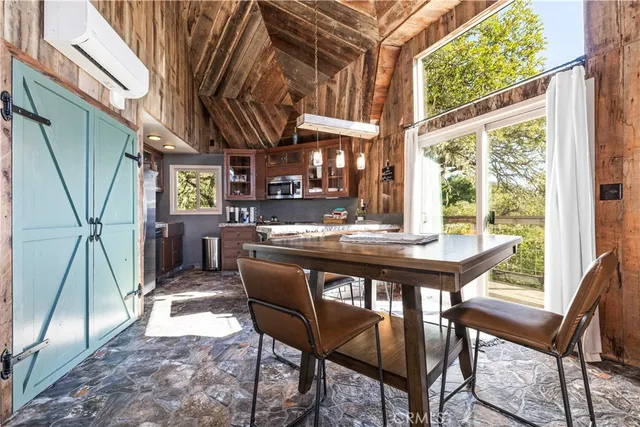 a dining room with a wooden table and chairs