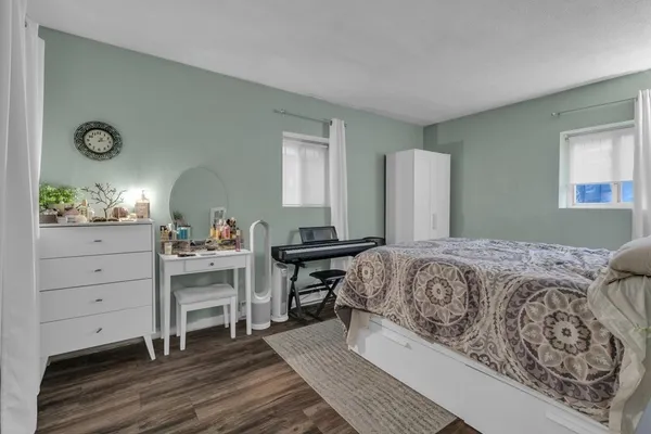a bedroom with a bed and a dresser in it