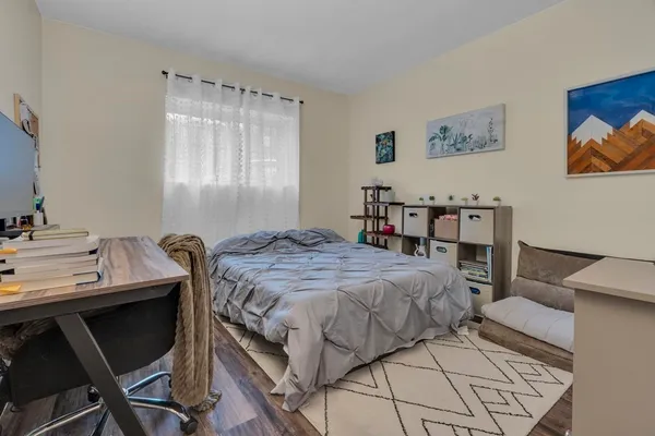 a bedroom with a bed and a table in it