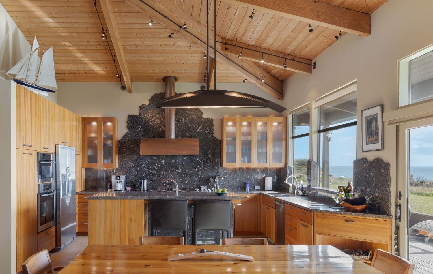 40445 Tide Pool The Sea Ranch, CA 95497 - Photo 13 of 75 a kitchen with stainless steel appliances kitchen island granite countertop a sink and cabinets