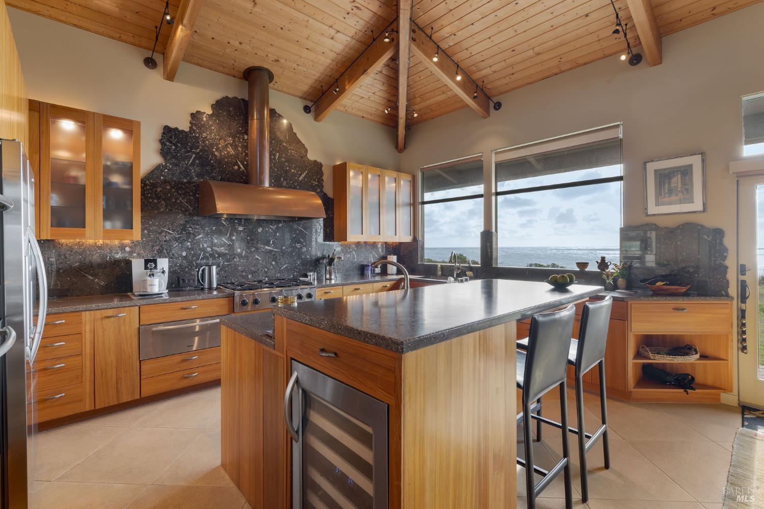 40445 Tide Pool The Sea Ranch, CA 95497 - Photo 15 of 75 a kitchen with stainless steel appliances granite countertop sink stove top oven and cabinets
