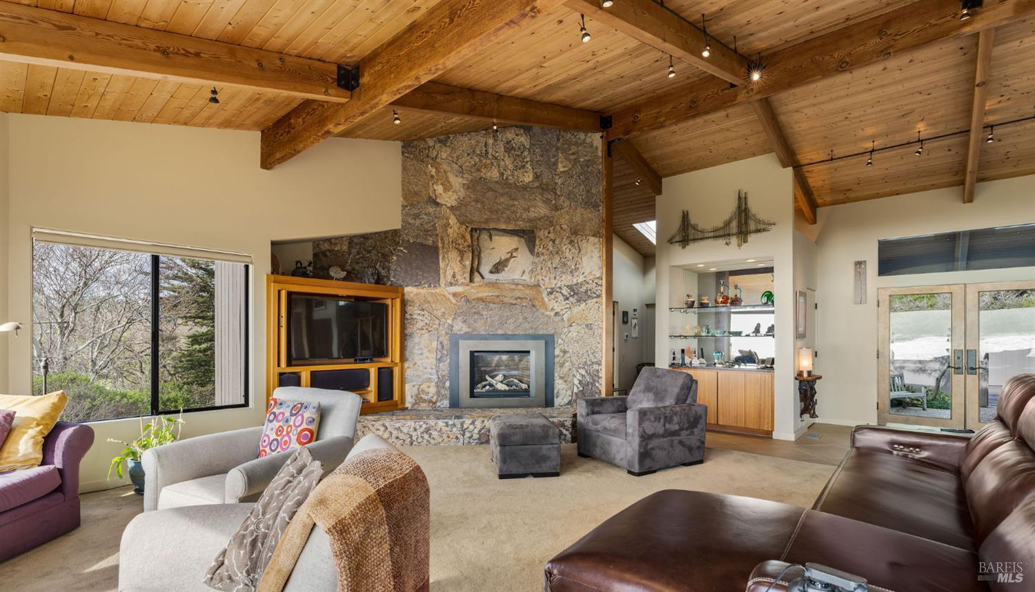40445 Tide Pool The Sea Ranch, CA 95497 - Photo 24 of 75 a living room with furniture a fireplace and a floor to ceiling window