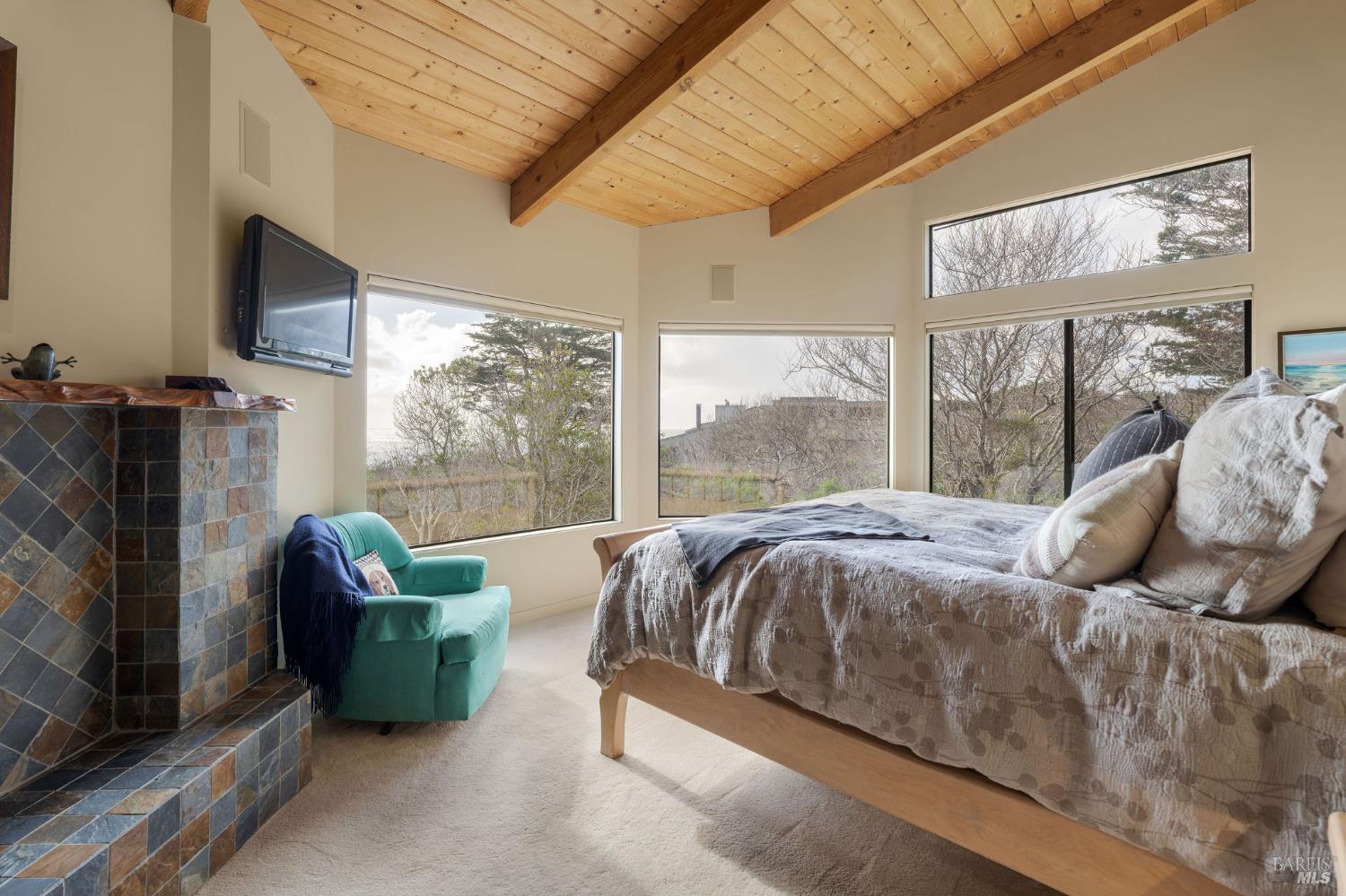 40445 Tide Pool The Sea Ranch, CA 95497 - Photo 26 of 75 a bed sitting in a bedroom next to a window with television