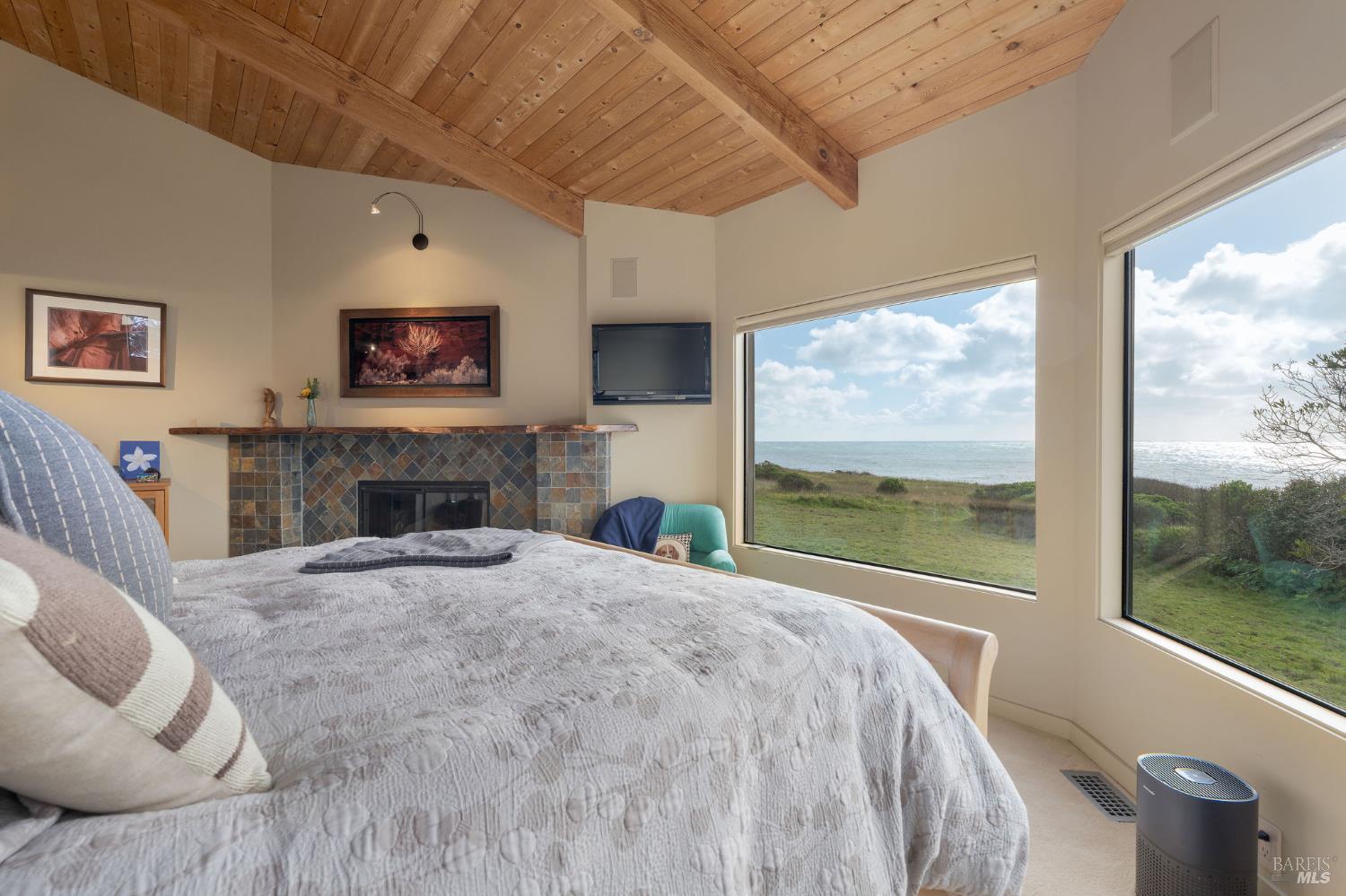 40445 Tide Pool The Sea Ranch, CA 95497 - Photo 27 of 75 a bed room with a bed and a fireplace