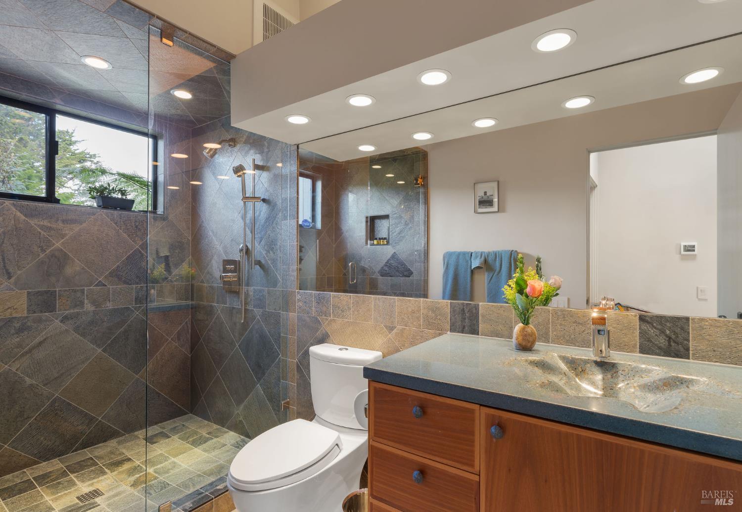 40445 Tide Pool The Sea Ranch, CA 95497 - Photo 41 of 75 a bathroom with a granite countertop sink a toilet a mirror and shower