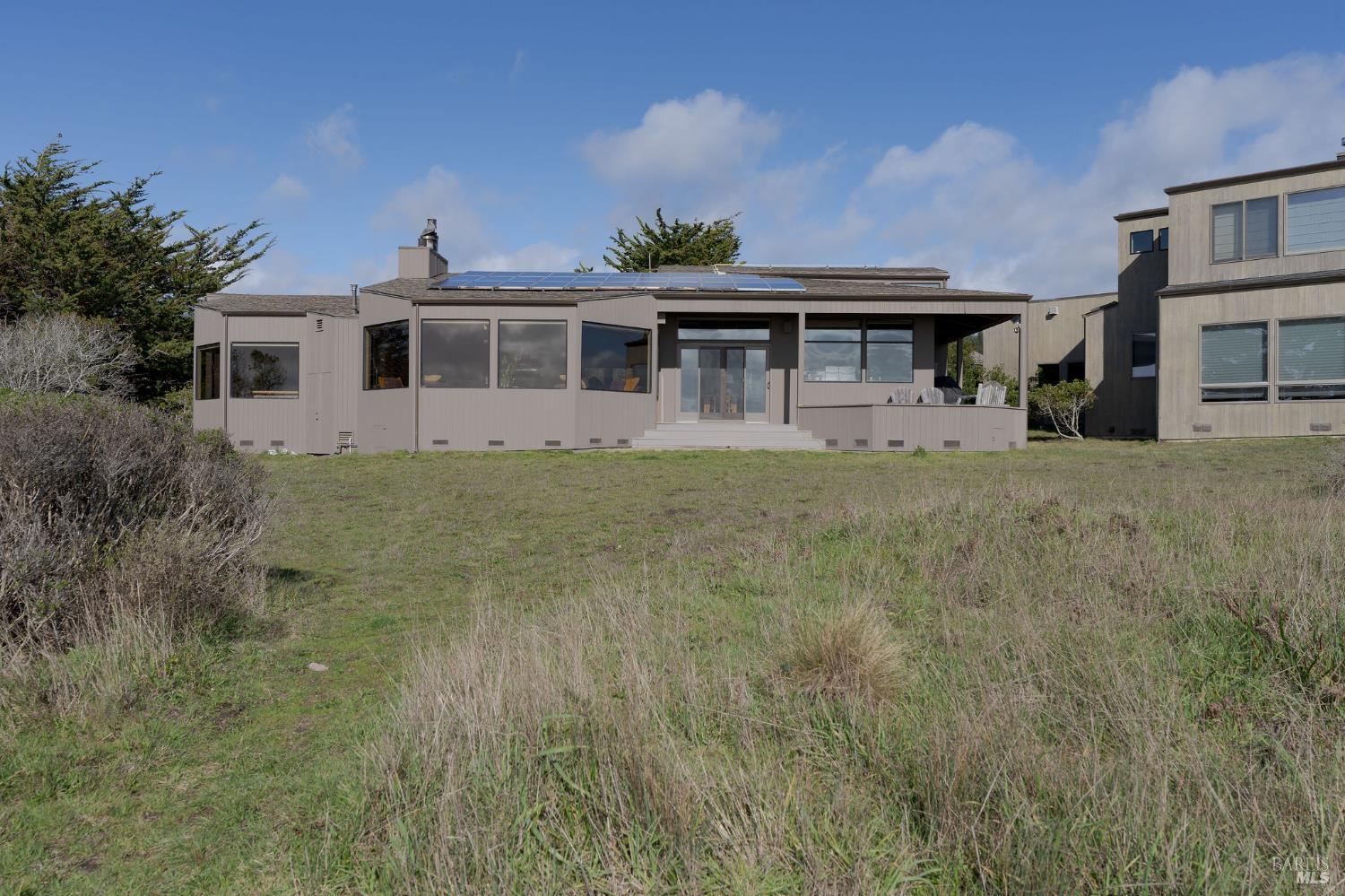 40445 Tide Pool The Sea Ranch, CA 95497 - Photo 61 of 75 a front view of a house with a garden