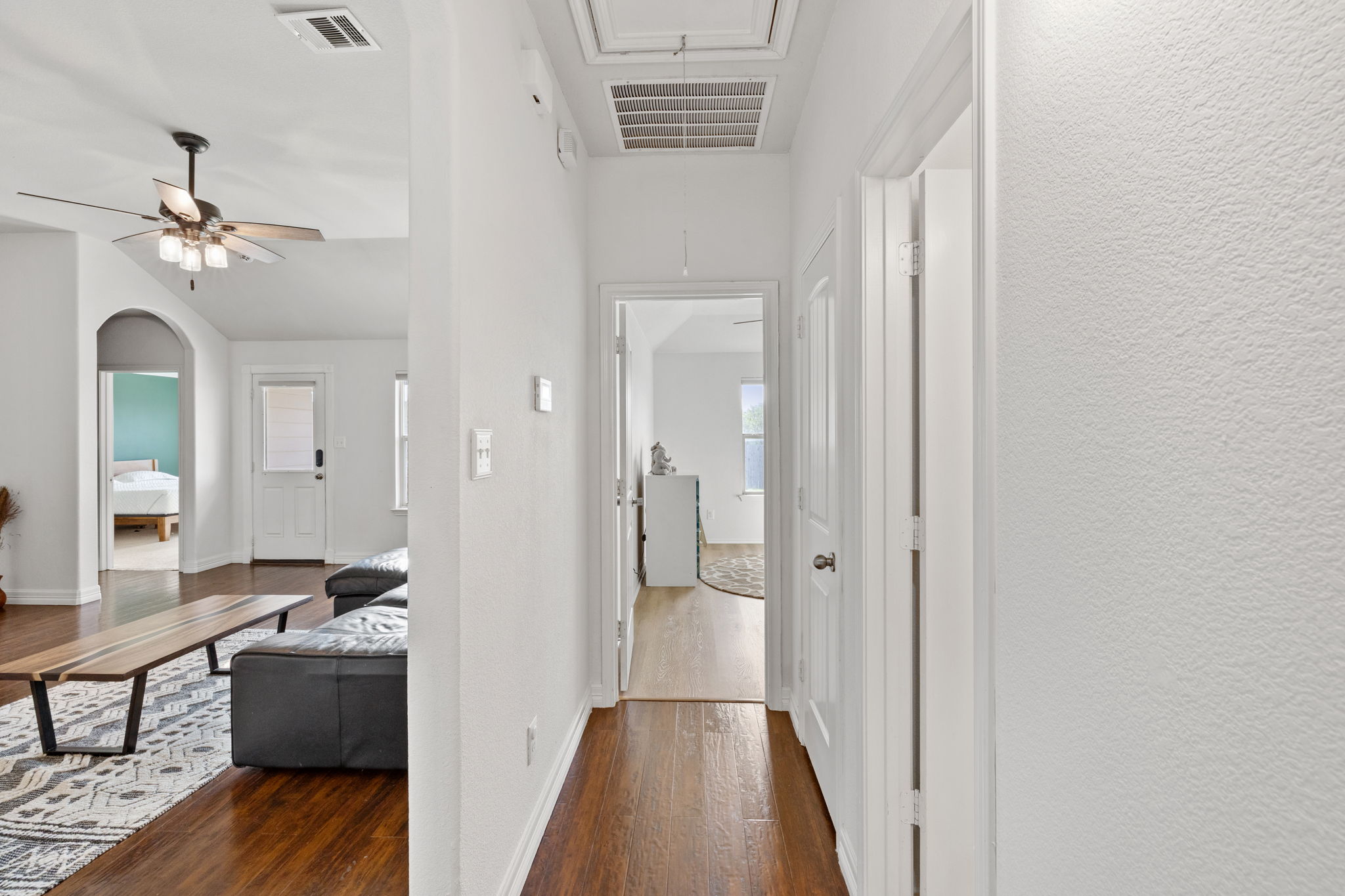 482 Travertine Trail Buda, TX 78610 - Photo 13 of 40 a view of a hallway view with wooden floor and staircase