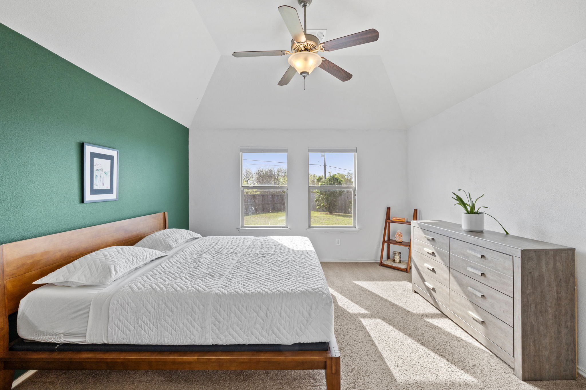 482 Travertine Trail Buda, TX 78610 - Photo 19 of 40 a bedroom with a bed dresser and a window
