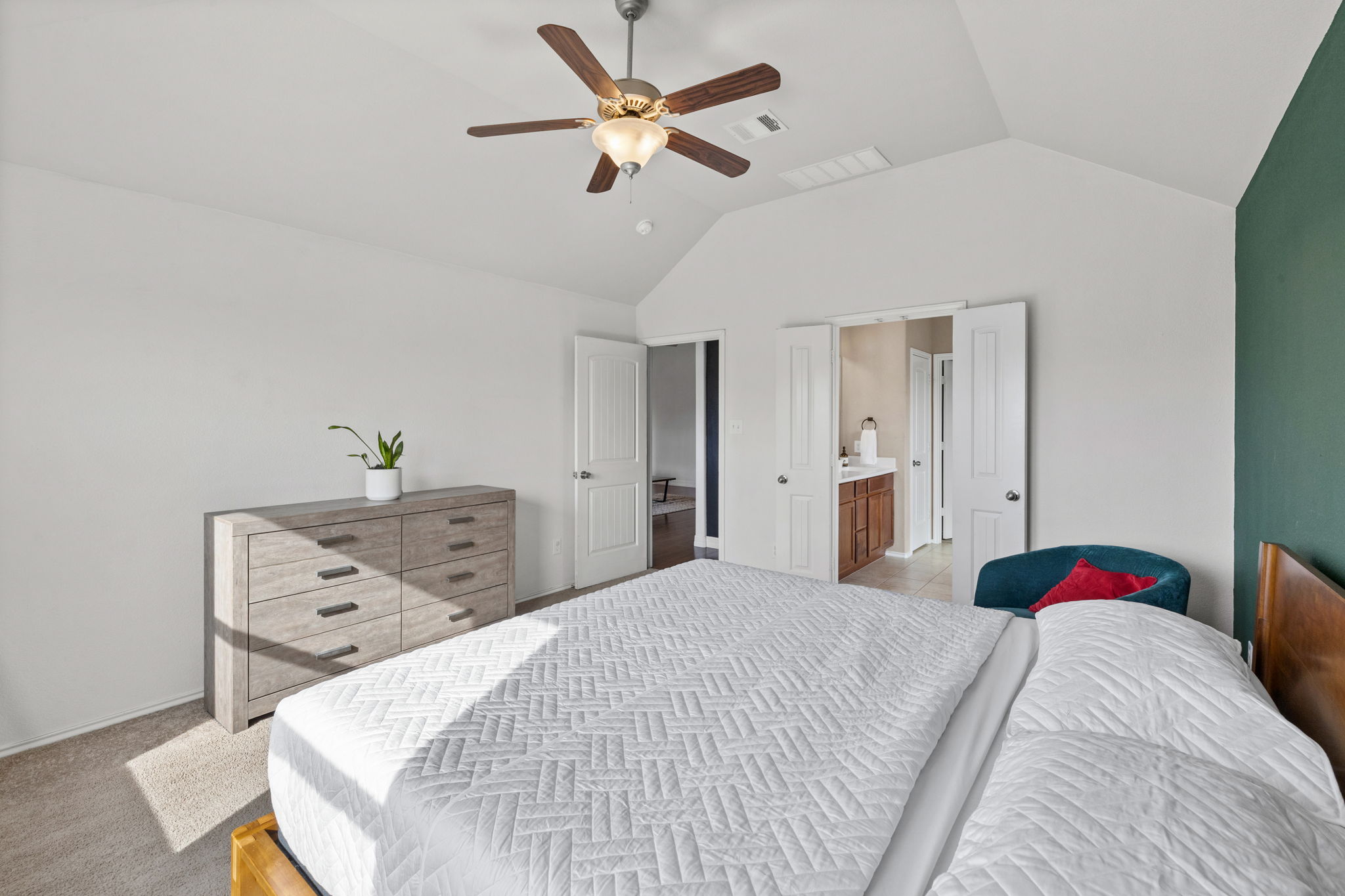 482 Travertine Trail Buda, TX 78610 - Photo 21 of 40 a bedroom with a bed and a chandelier