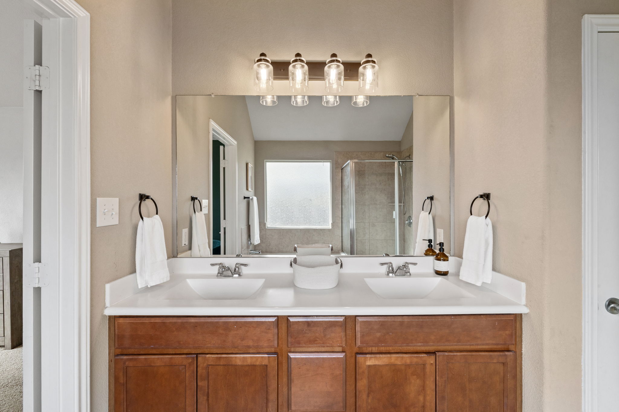 482 Travertine Trail Buda, TX 78610 - Photo 23 of 40 a bathroom with a double vanity sink and a mirror