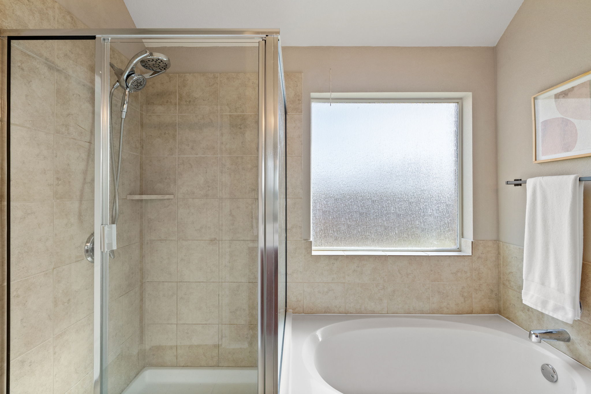 482 Travertine Trail Buda, TX 78610 - Photo 24 of 40 a bathroom with a bathtub and a shower