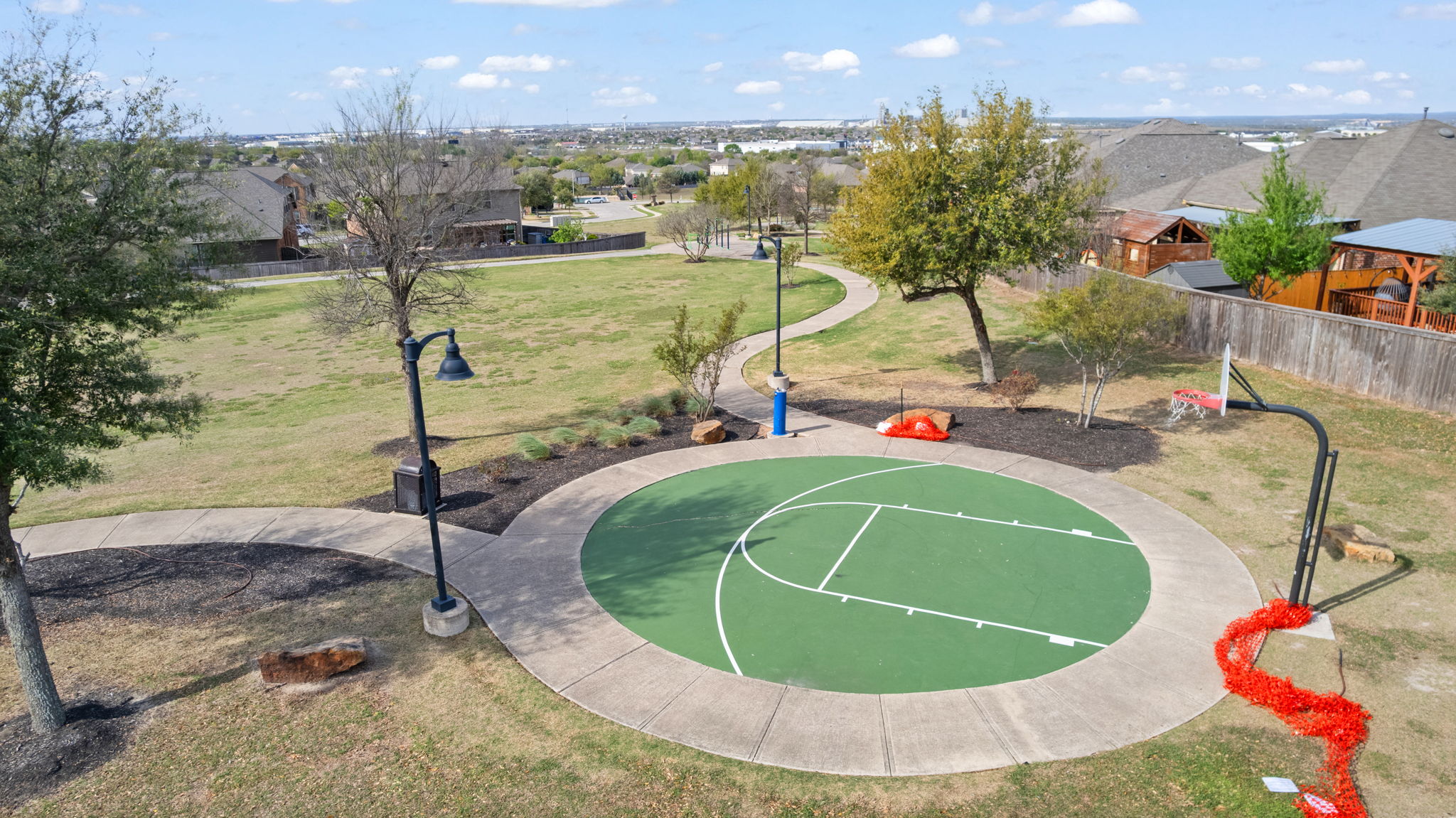 482 Travertine Trail Buda, TX 78610 - Photo 35 of 40 a view of a swimming pool with a chairs and tables in the background