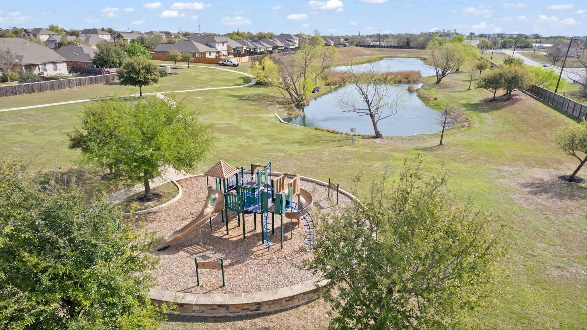 482 Travertine Trail Buda, TX 78610 - Photo 39 of 40 a view of a lake with a yard and mountain in the background