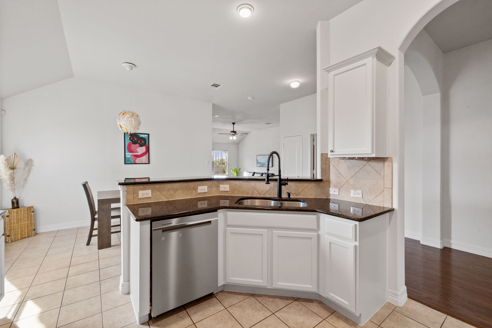 482 Travertine Trail Buda, TX 78610 - Photo 4 of 40 a kitchen with stainless steel appliances granite countertop a sink and a refrigerator