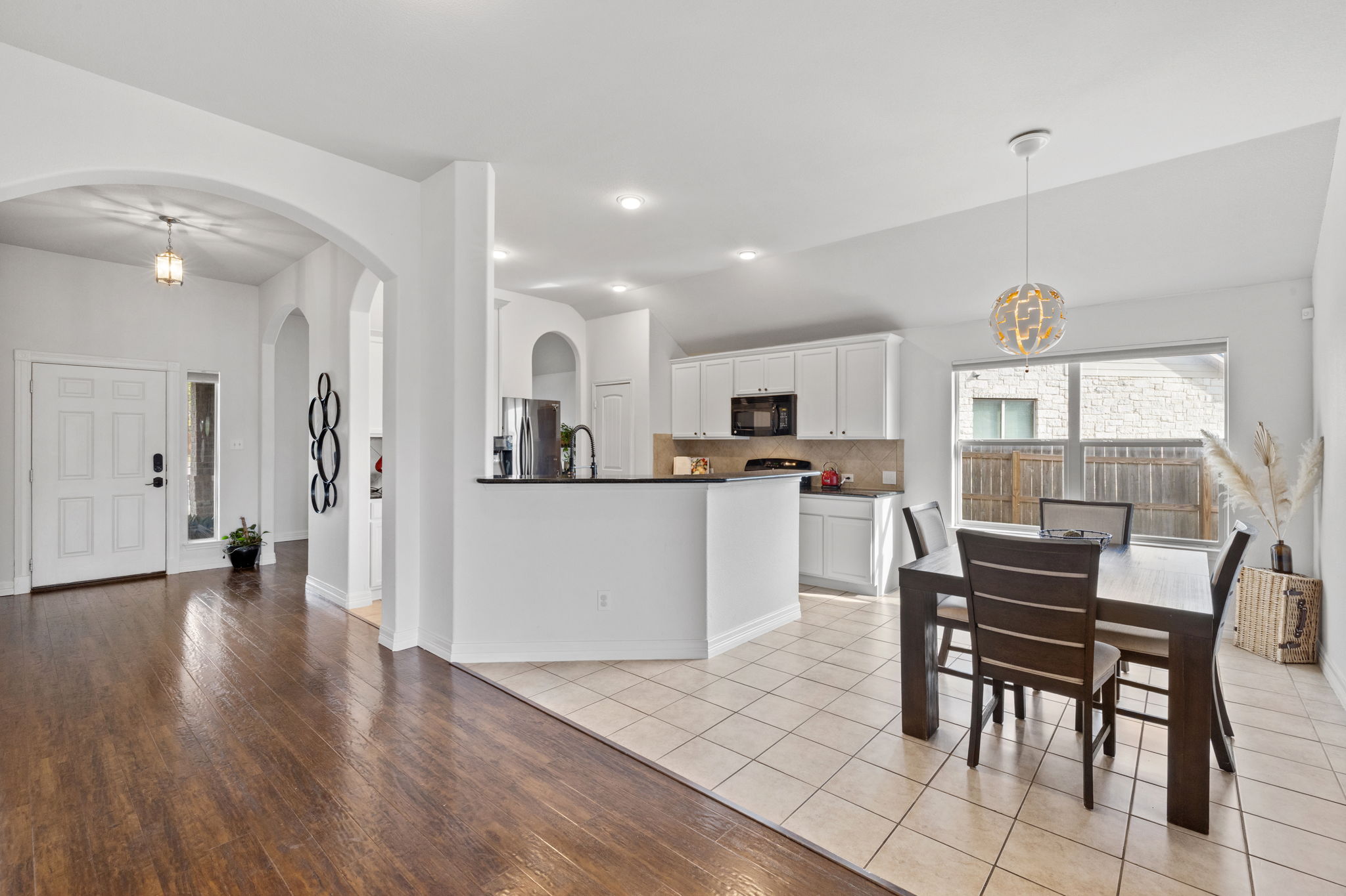 482 Travertine Trail Buda, TX 78610 - Photo 6 of 40 a view of a dining room with furniture and wooden floor