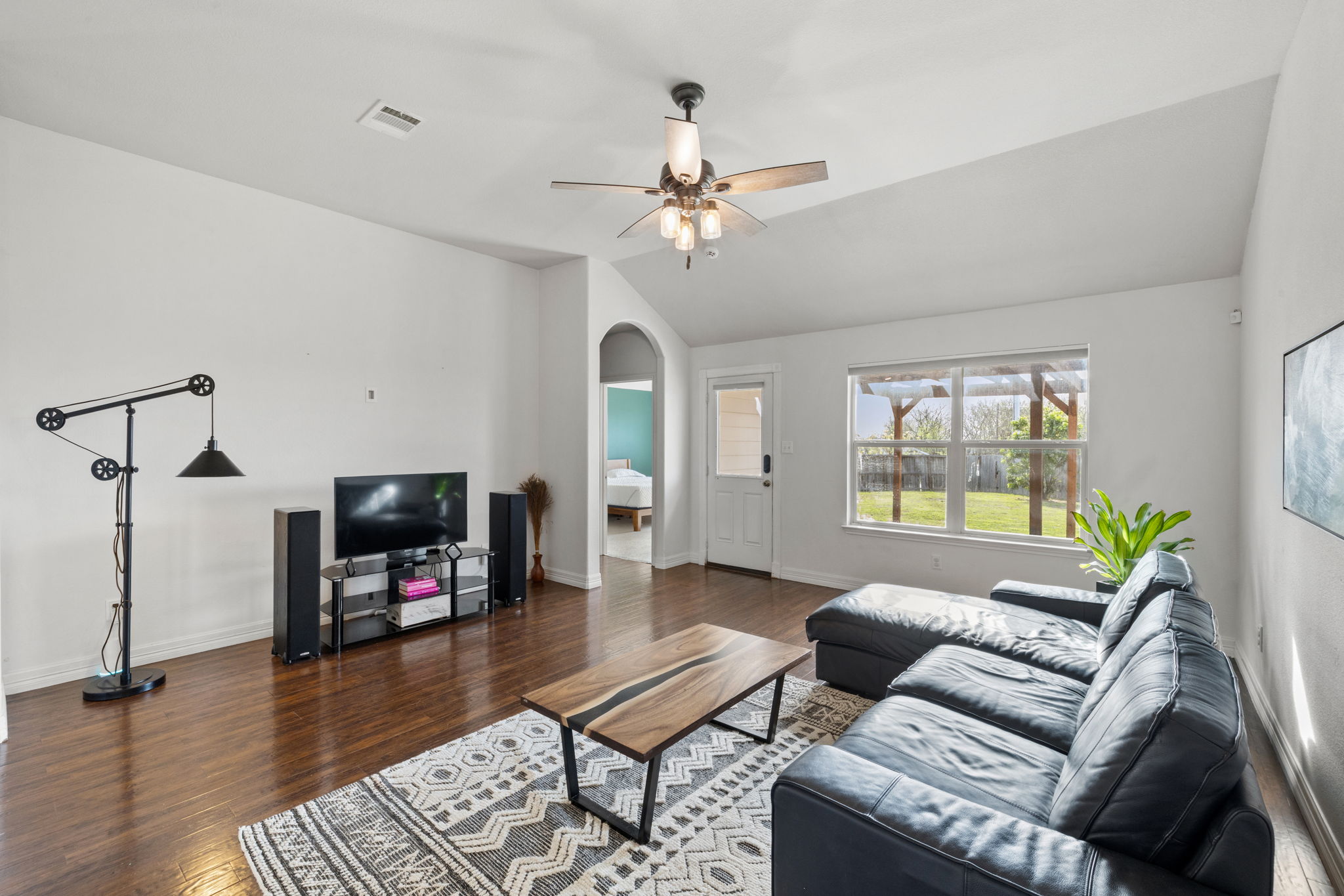482 Travertine Trail Buda, TX 78610 - Photo 8 of 40 a living room with furniture a fireplace and a flat screen tv