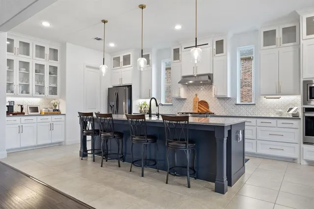 a kitchen with granite countertop a sink cabinets and window