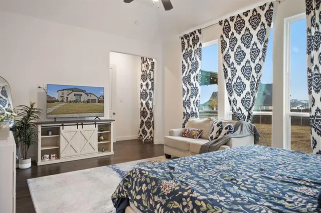 a bedroom with a bed and a dresser in it