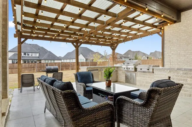 a view of a patio with couches potted plants and a table