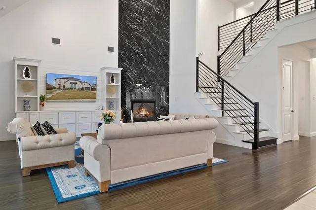 a living room with furniture and a hard wood floor