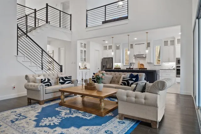 a living room with furniture wooden floor and a view of kitchen
