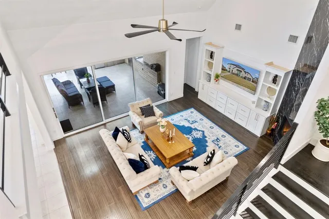 a view of living room with furniture and wooden floor