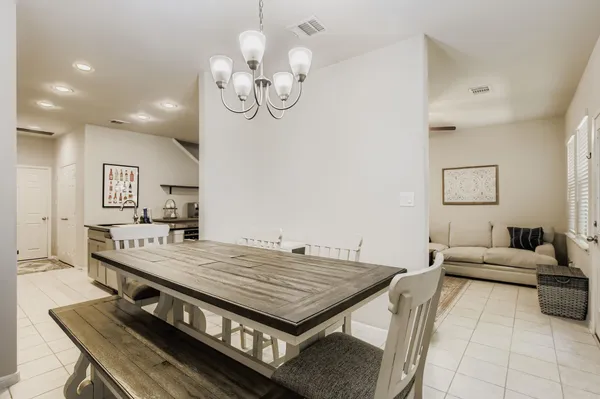 a living room with dining table and wooden floor