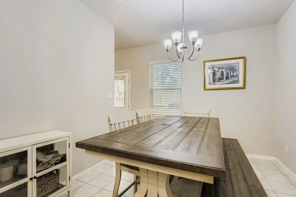 a view of a dining room with furniture and chandelier