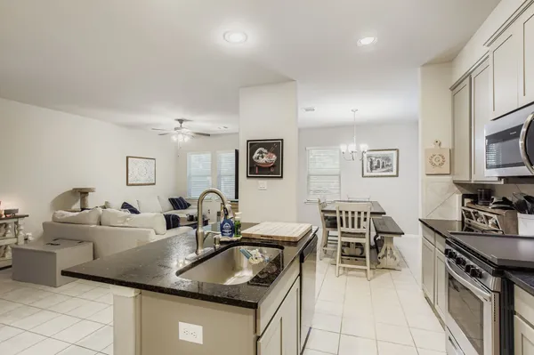 a kitchen with granite countertop a sink and a stove top oven