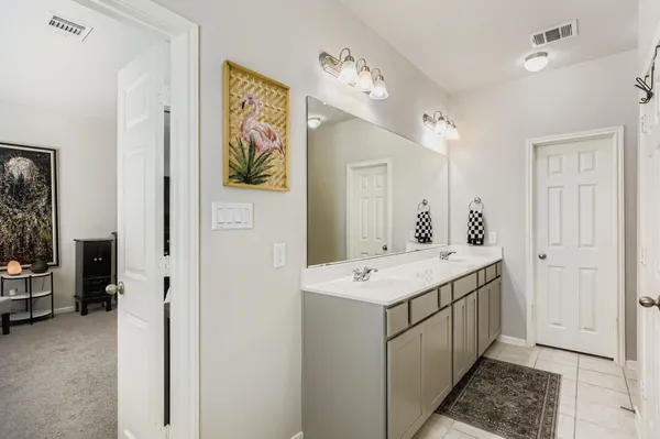 a bathroom with a sink a mirror and a shower