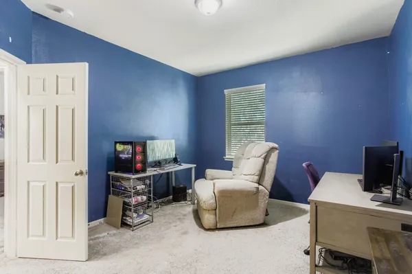 a living room with furniture a flat screen tv and a window