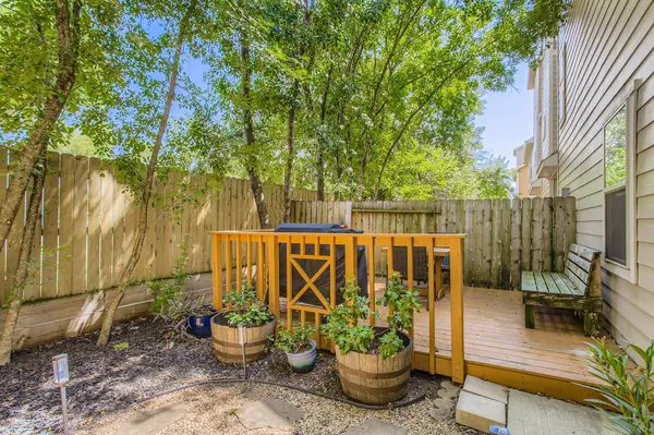 a view of a patio with chairs and potted plants