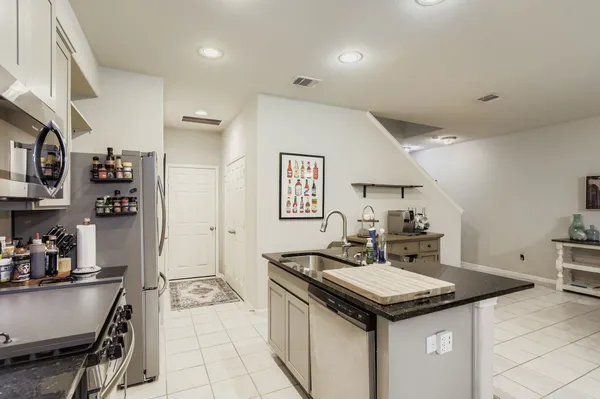 a kitchen with a stove and a refrigerator