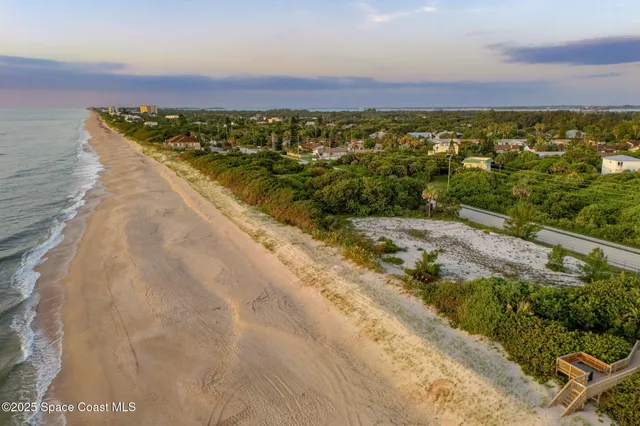 an aerial view of residential building and ocean