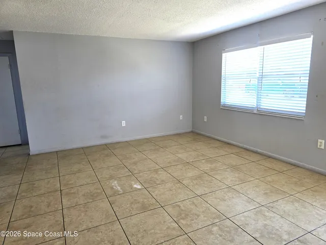 a view of an empty room and a window