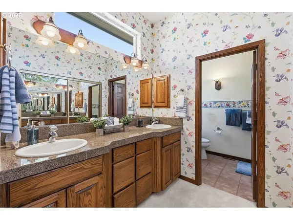 a bathroom with a sink a toilet and shower curtain