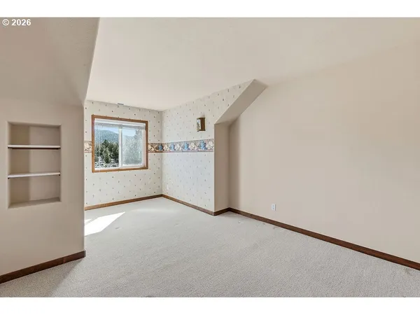 a view of an empty room with a window