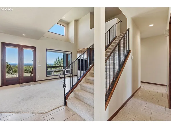 a view of staircase with furniture and a window