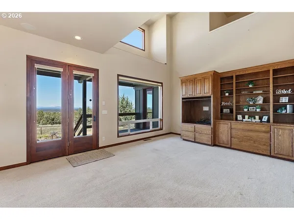 a living room with furniture and large windows