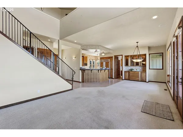 a view of a hallway with wooden cabinet and stairs